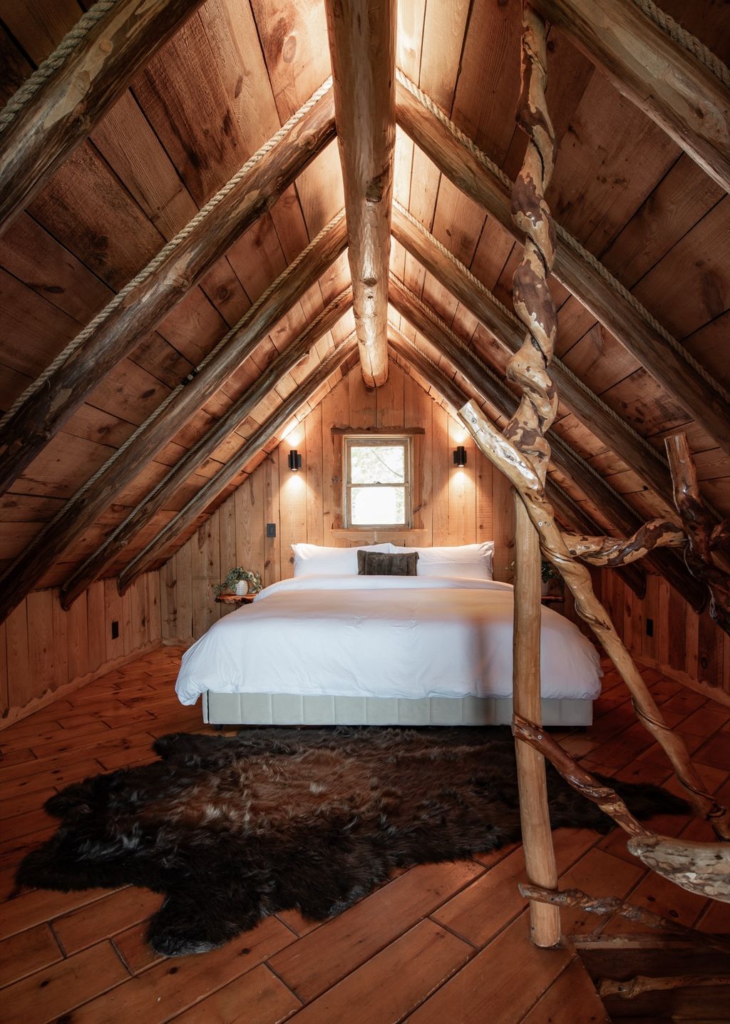 Loft bedroom under the hand-hewn A-roof
