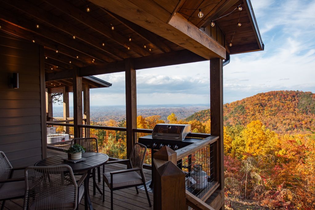 Covered deck with dining table and mountain views